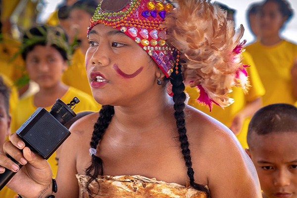 Young girl in traditional dress with a microphone
