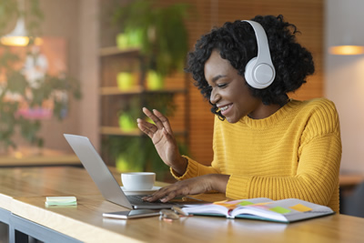 woman using laptop and headphones