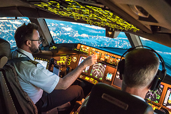 Two pilots inside the cockpit while flying.