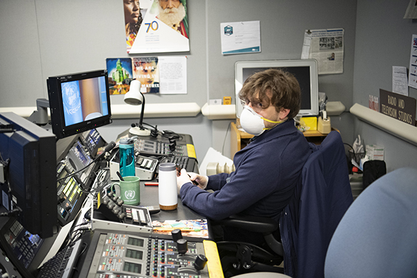 Broadcast engineer works with mask on. 