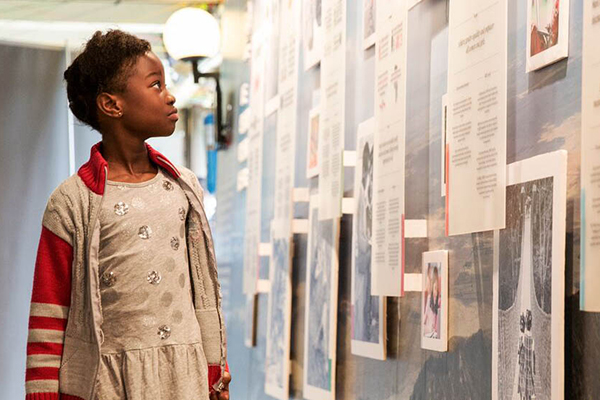 Girl walks through an exhibit.