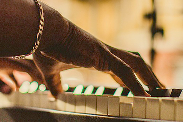 Close-up of hands playing the piano.