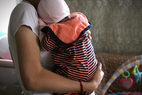 Mother holding her baby