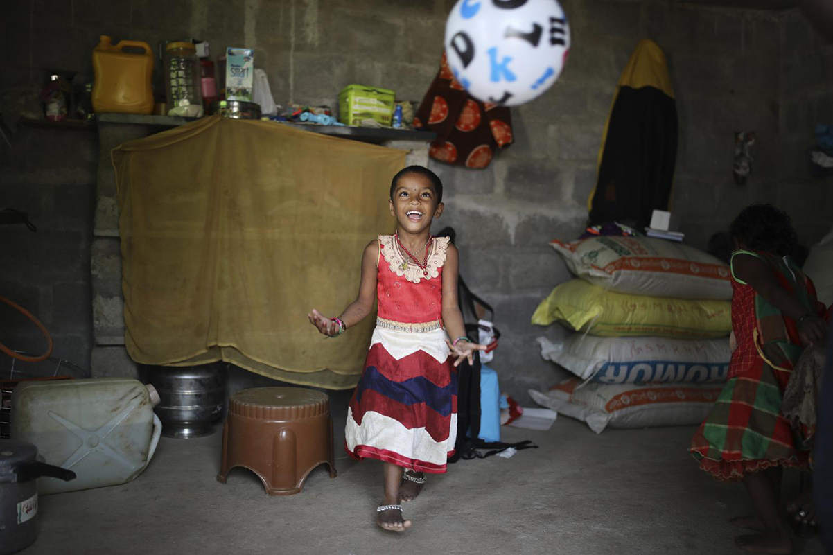 girl playing with a ball at home