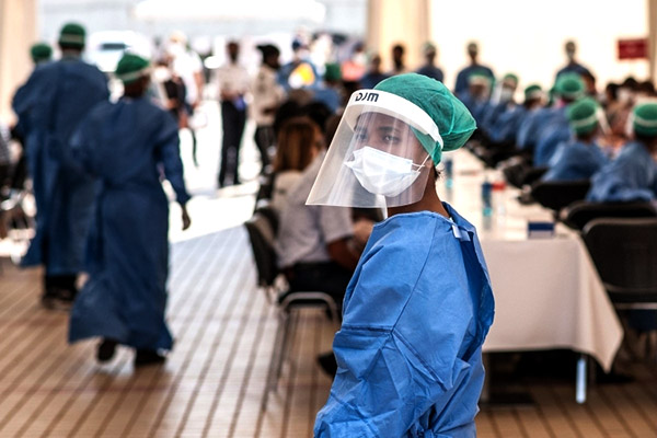 Woman wearing protective gear at testing site.