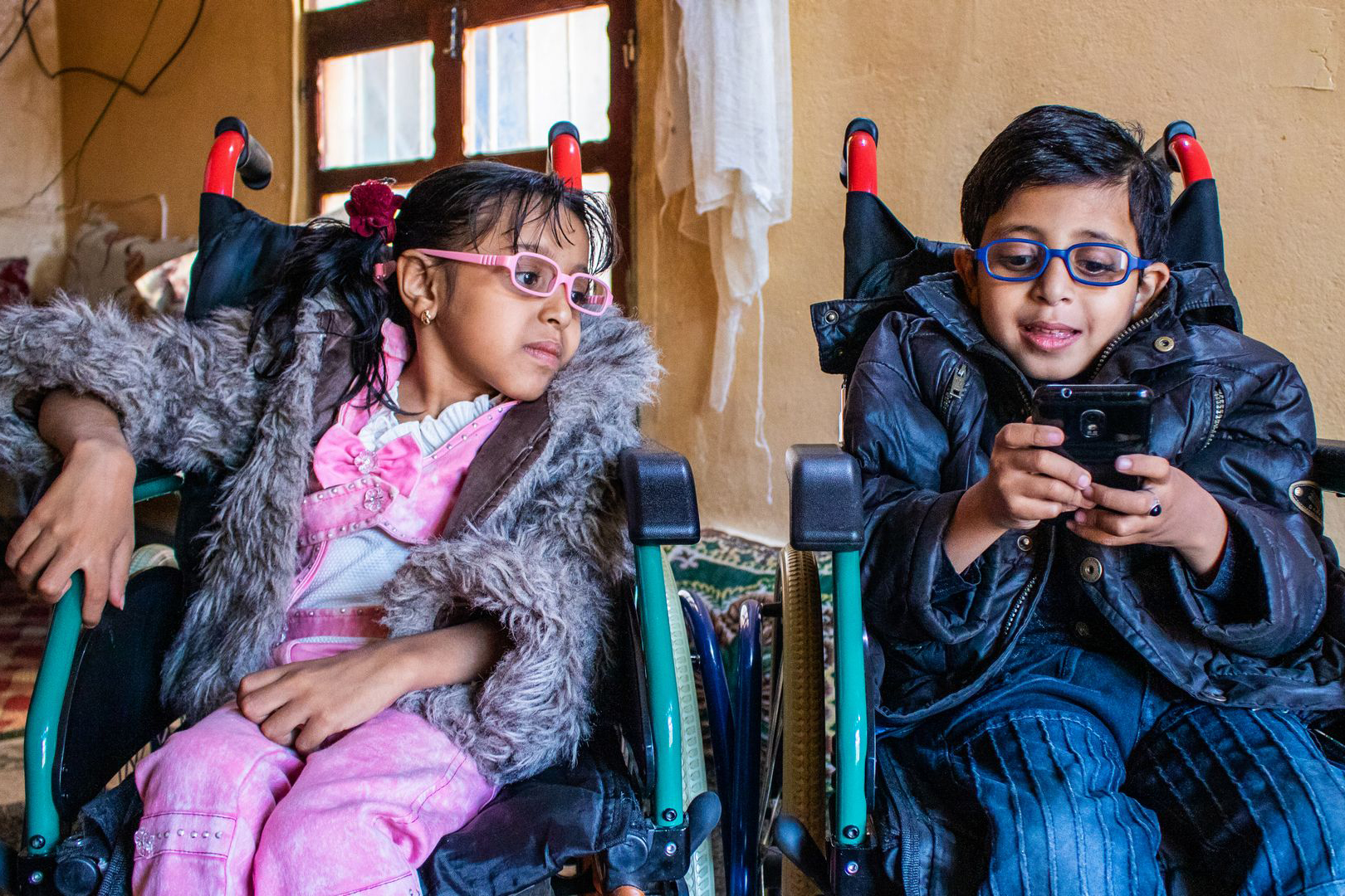 young girl and boy in wheelchairs