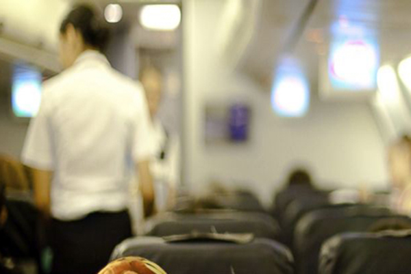 Blurred image of the inside of an airplane cabin.