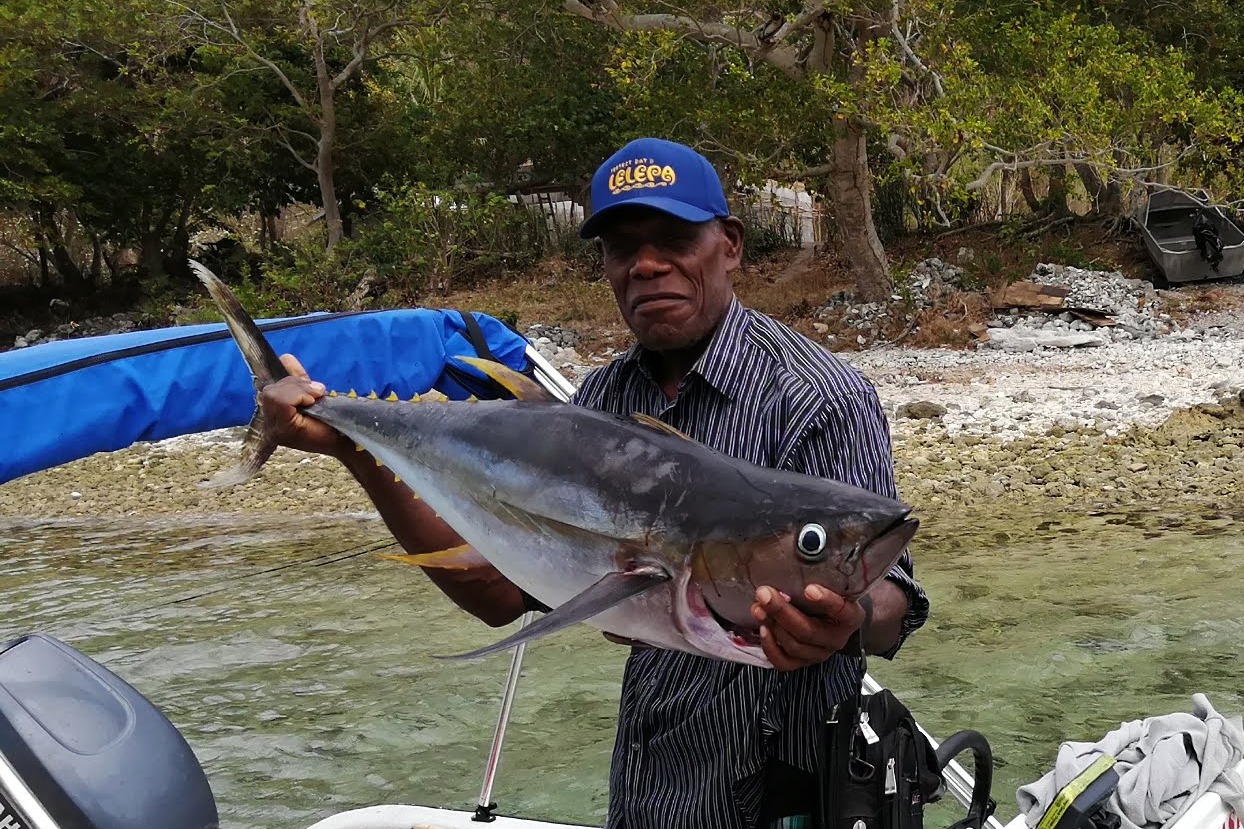 fisherman holding large catch