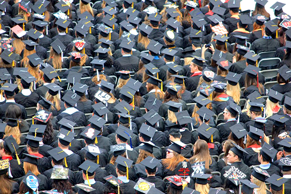 View from above of a crowd with graduation caps. 