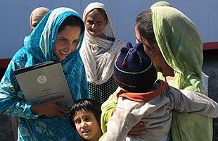 health worker with mother and children