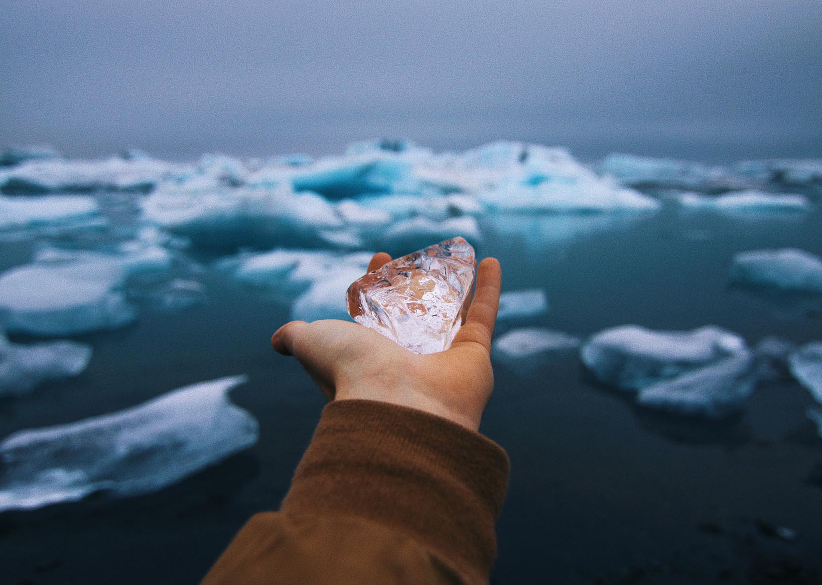 hand holds a block of ice