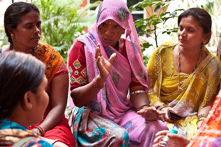 Four women sitting together talking.