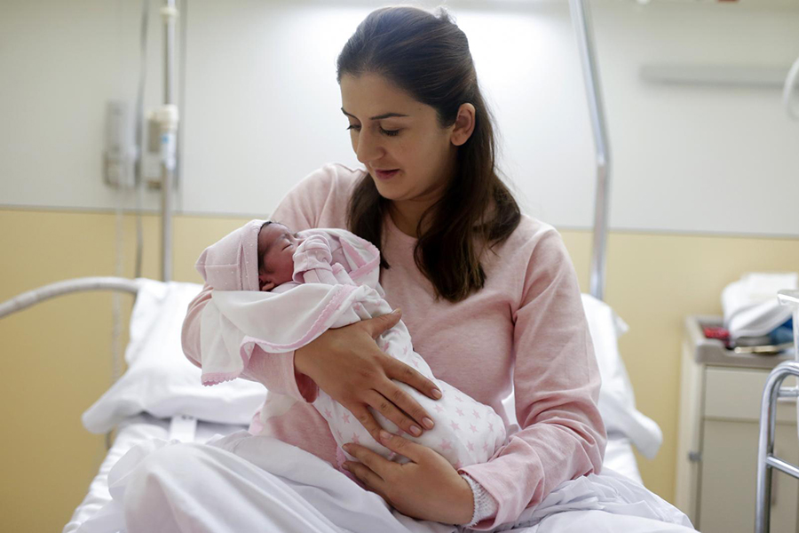 A mother holds her new-born.