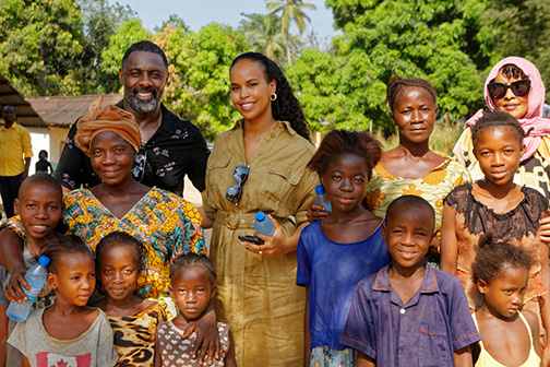 Idris and Sabrina Elba with women and children