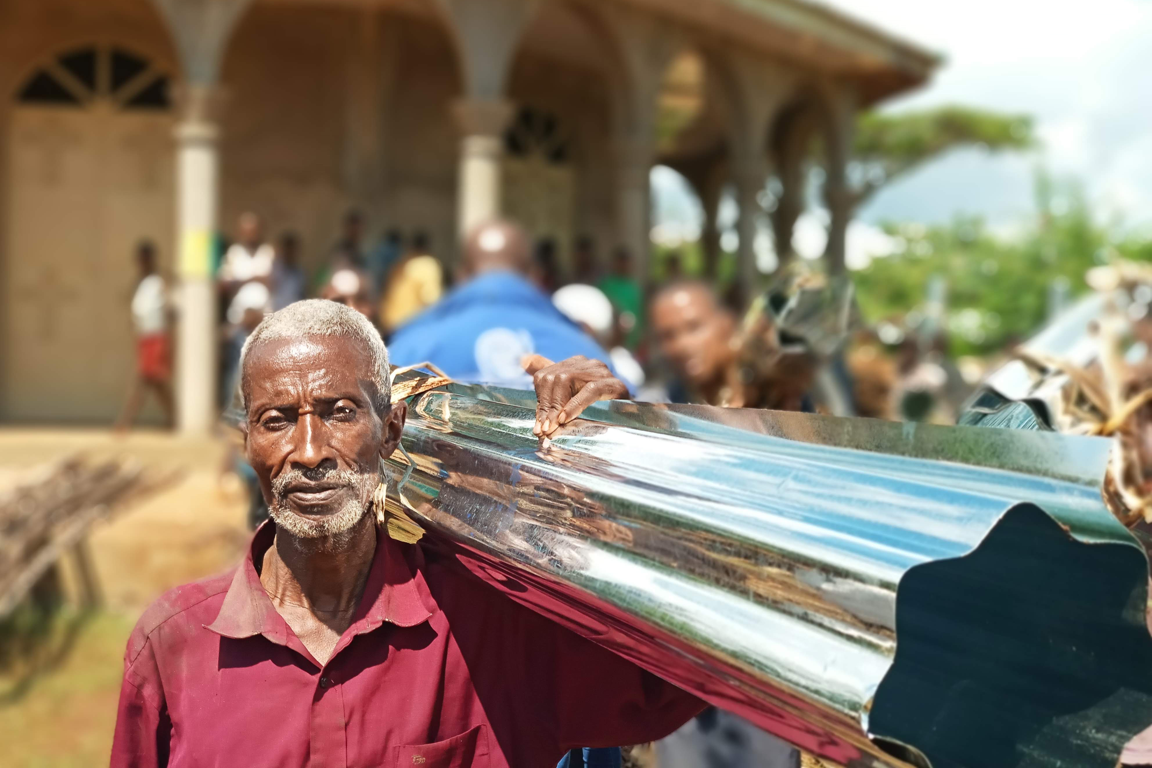 man carrying construction materials