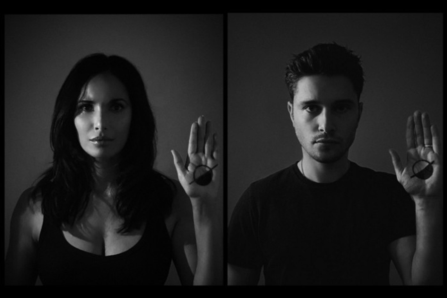 Portraits of two people holding up their right hand with campaign logo on their hands. 