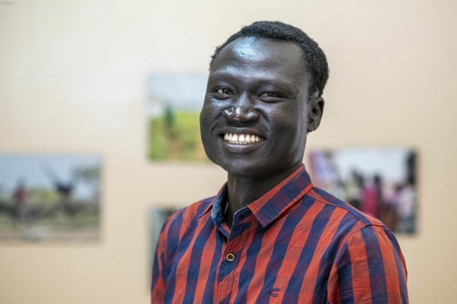 The portrait of a man smiling.