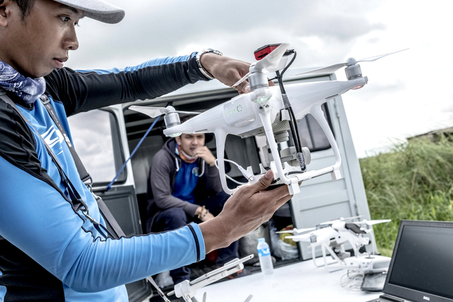 A man holds up a drone.