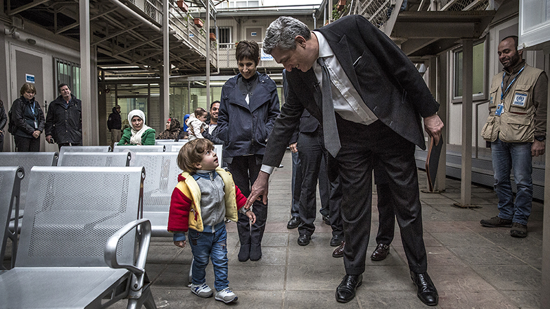 Filippo Grandi, UN High Commissioner for Refugees, greets a young Syrian boy at a UNHCR refugee registration centre in Beirut.