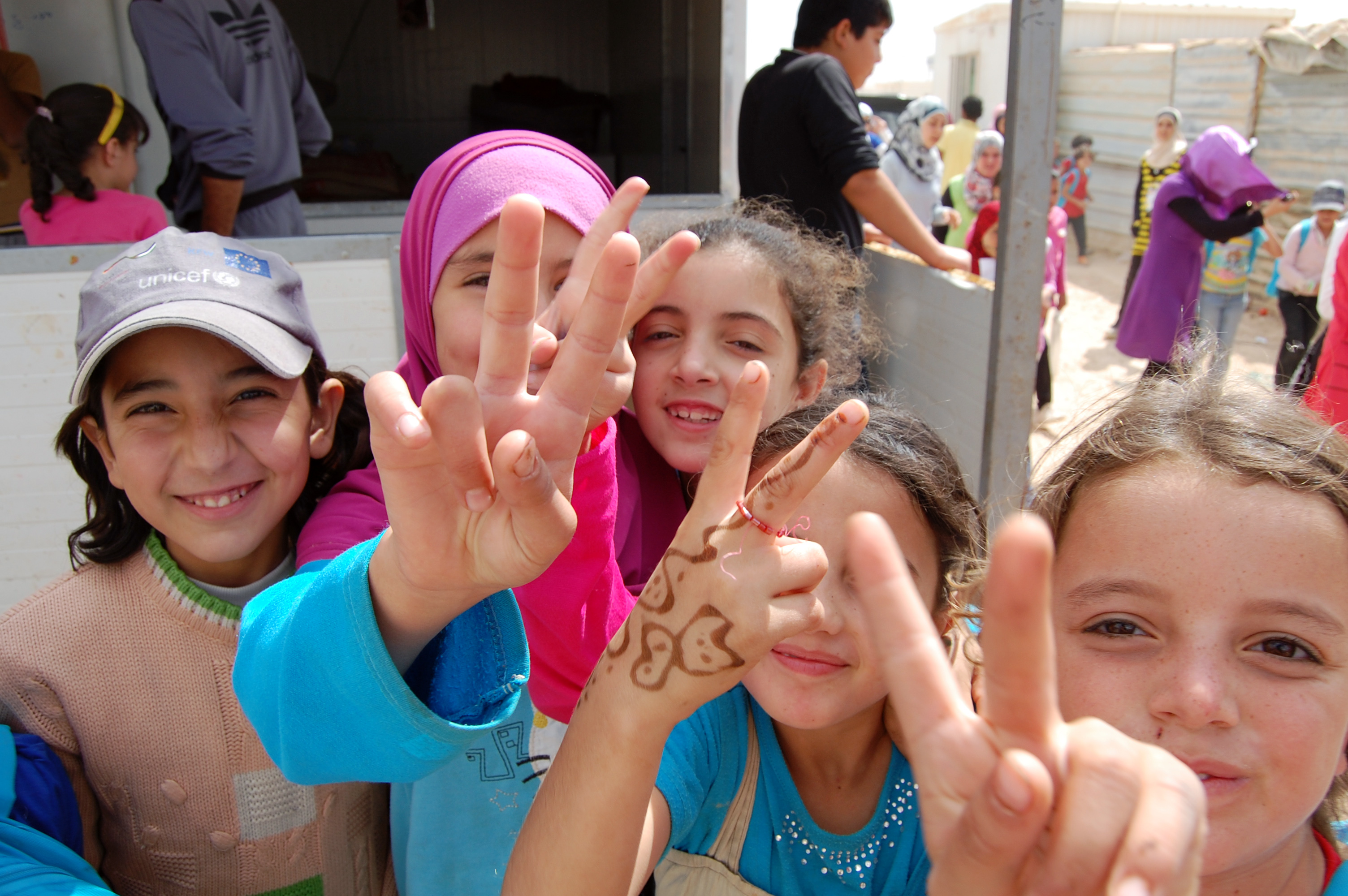 Refugee children in Jordan show hand peace sign