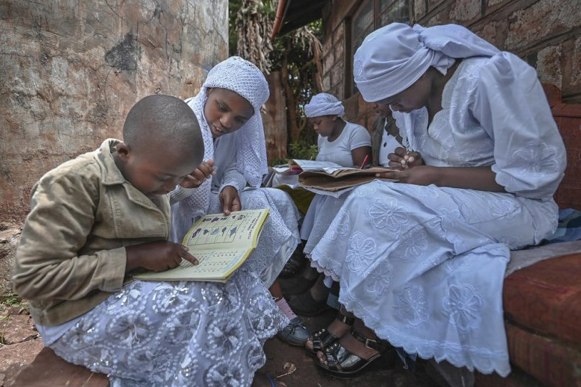 Nosizi Reuben assists her sisters with their studies