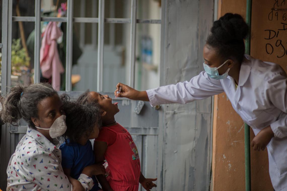 children receiving polio vaccine through the mouth