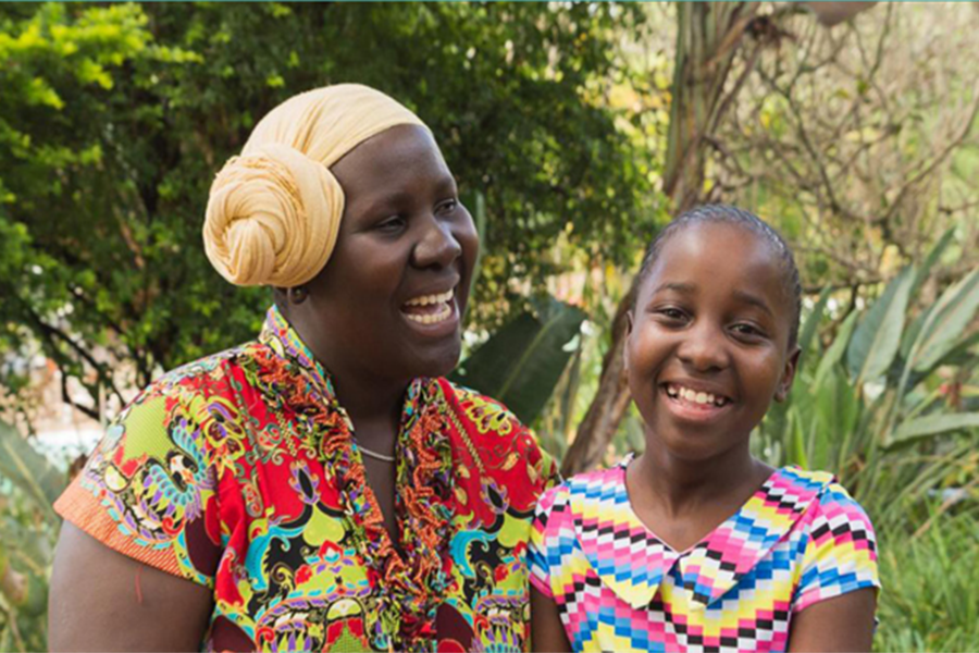 A woman and a small girl smile. 