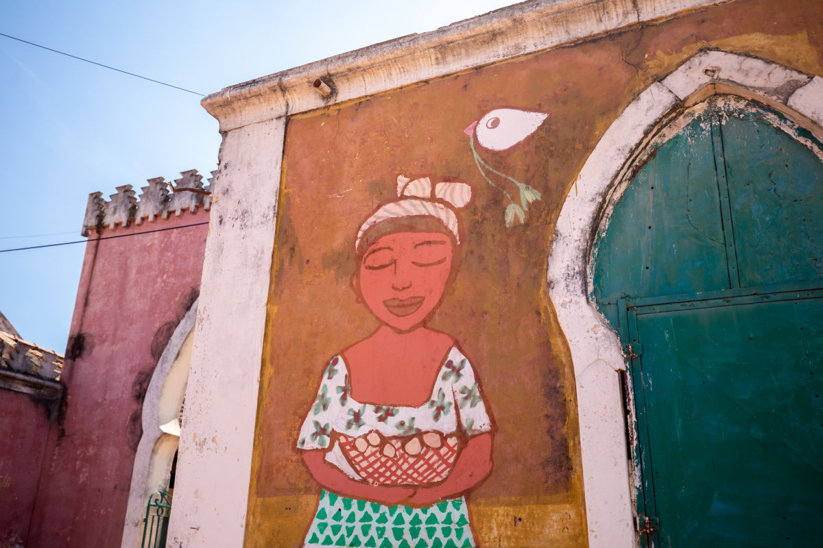 mural of woman with basket and dove with flowers