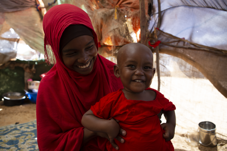 A joyous Halima Sharmaake at home with her mother Amran Mohamed weeks after recovering from Severe Acute Malnutrition at Hodan stabilization center in Mogadishu, Somalia.