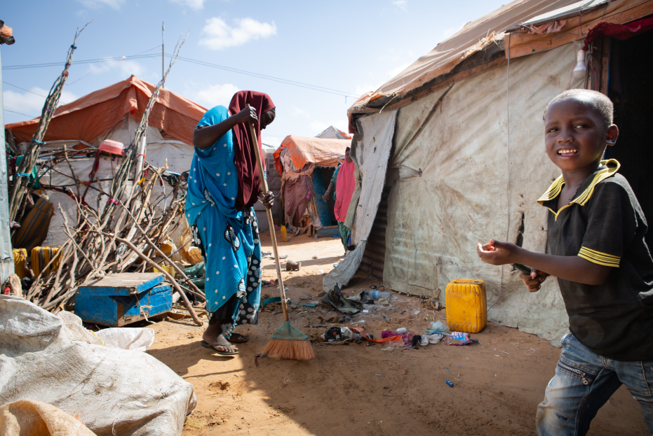 Khadija Ibrahim (25) sweeps her compound in preparation of building a makeshift kitchen at her home in Kahda IDP camp, Mogadishu.