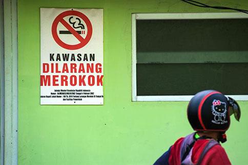 child passing no smoking sign