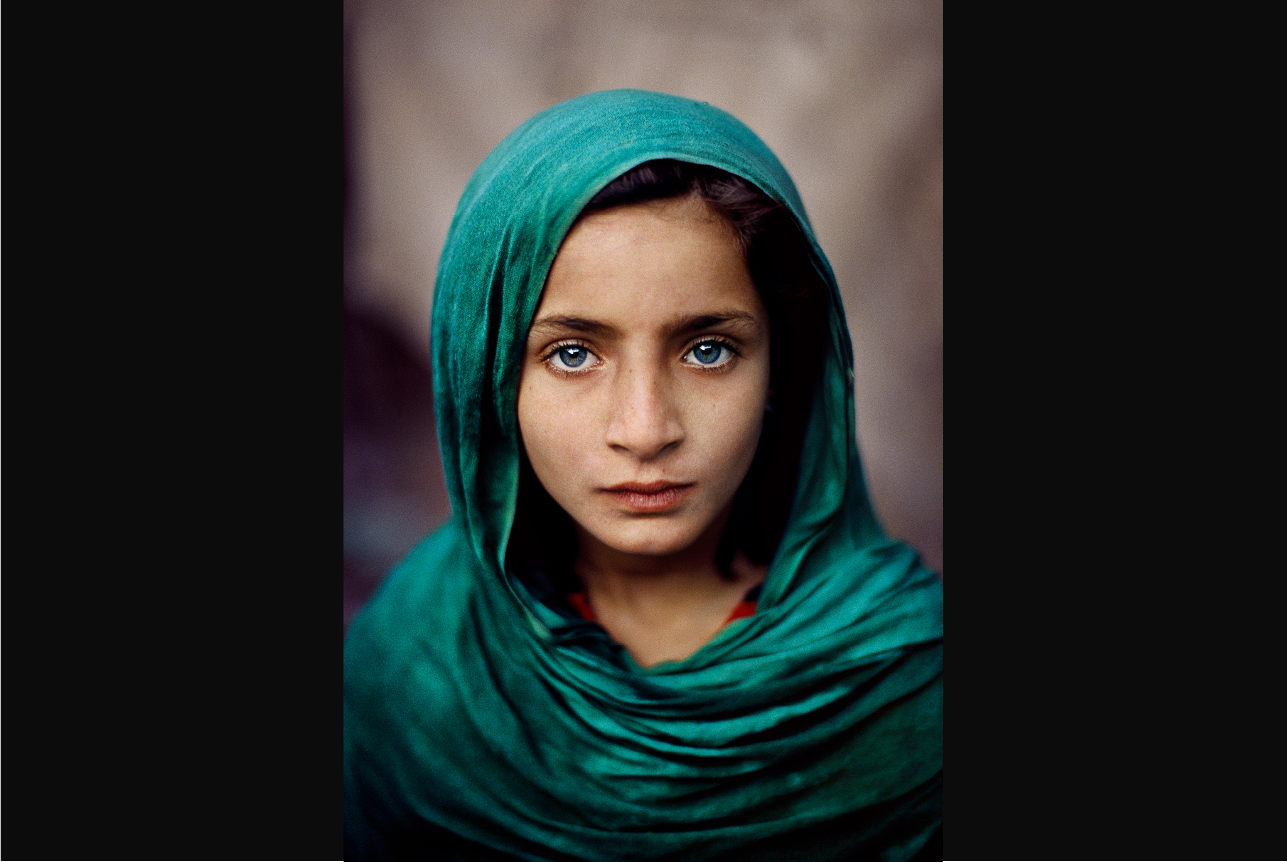 This young ten-year old Afghan refugee girl living in Peshawar, Pakistan, had never seen her homeland of Afghanistan when Steve McCurry took this portrait.