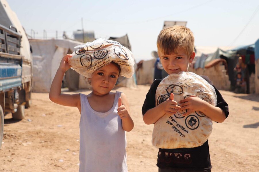Syrian children with bags of food