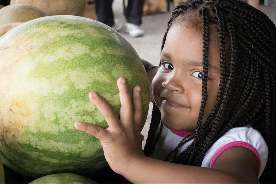 Girl with a big watermelon in her hands. 