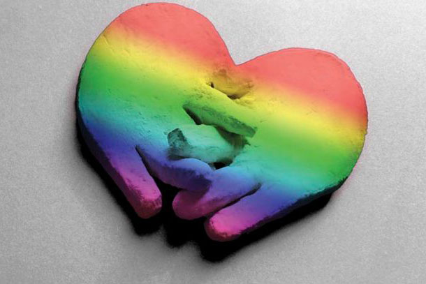 clay hands united in a rainbow heart