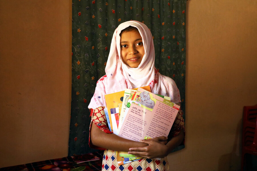 smiling girl holding books