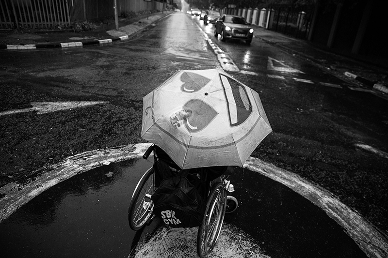 view from above of man in wheelchair with umbrella