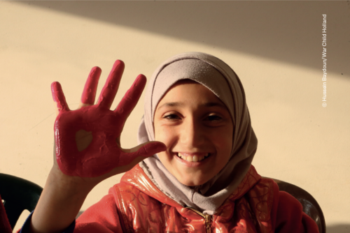 child holding up palm painted red