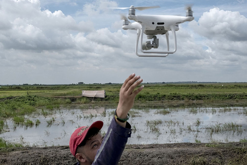 man launching a drone