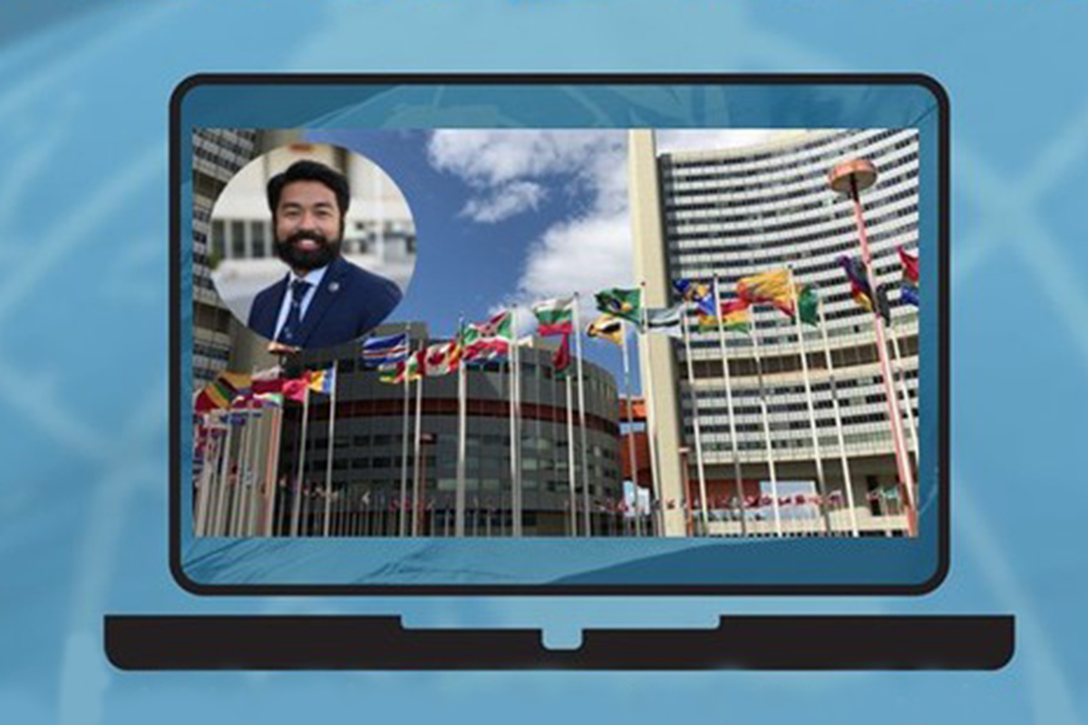 Illustration of a laptop screen showing the UN in Vienna and a bubble of a tour guide. 