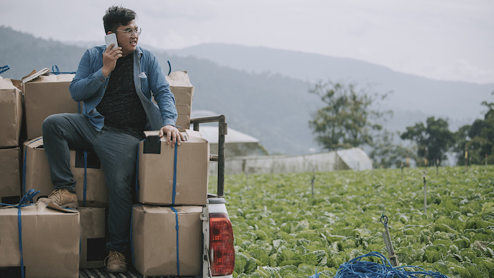 man talking on phone in field