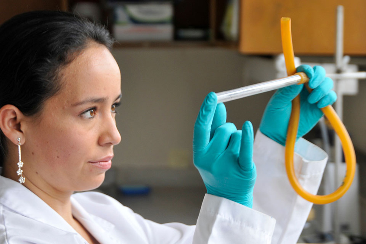 A woman working with a test tube. 