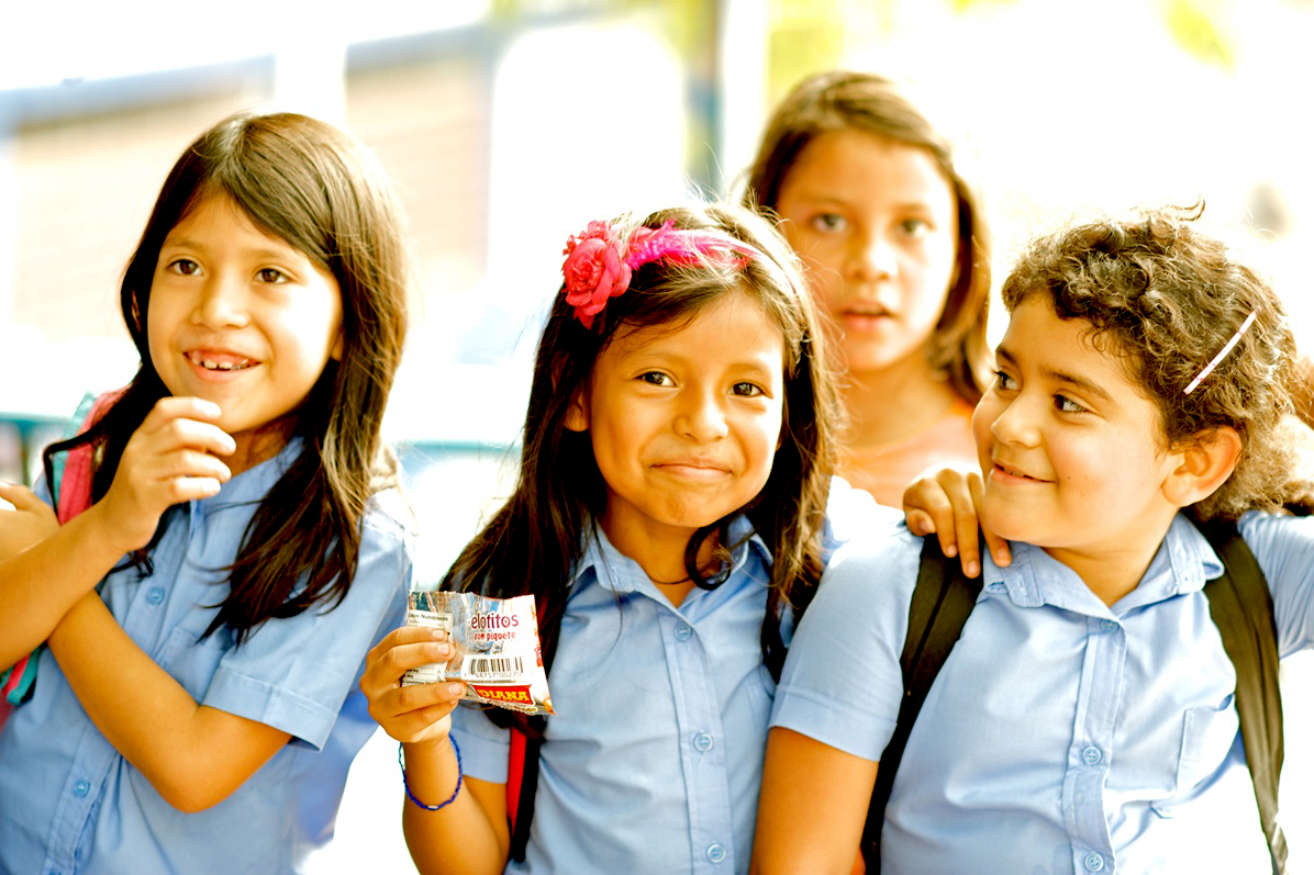 Group of smiling girls in school uniform.