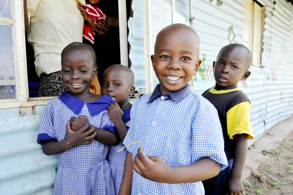 A group of smiling children in school uniform.