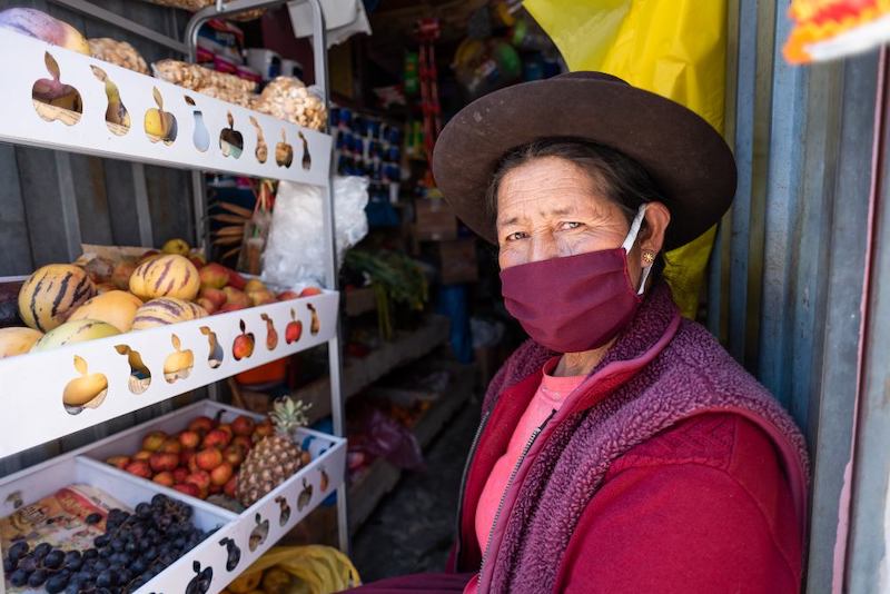 Peruvian woman at fruit stand