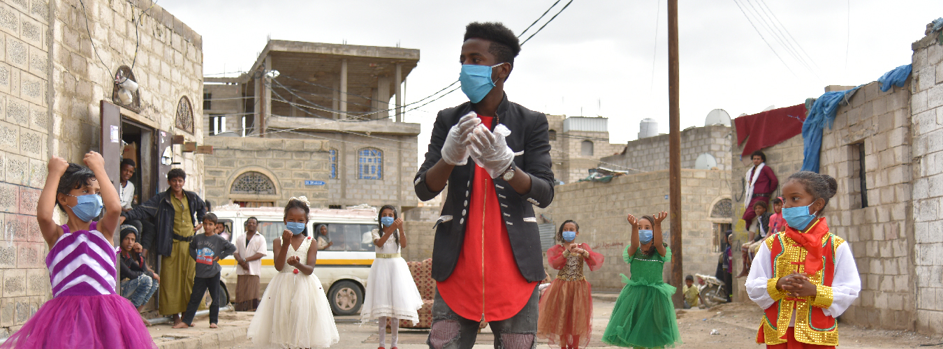 Rauf Salem, a volunteer, instructs children on the right way to wash their hands