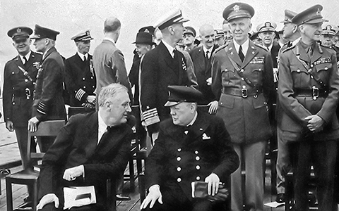 President Roosevelt at left and Prime Minister Churchill at right on deck of ship in Atlantic Ocean in 1941.