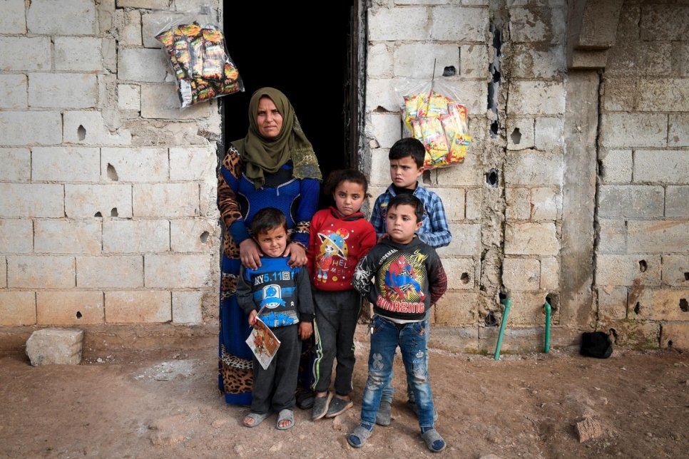 Syrian family outside their home