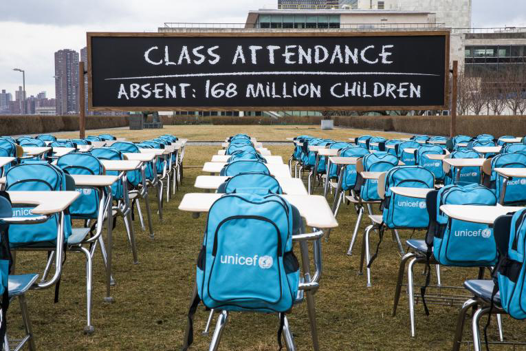 Installation at UN Headquarters in New York with 168 empty desks with UNICEF backpacks.