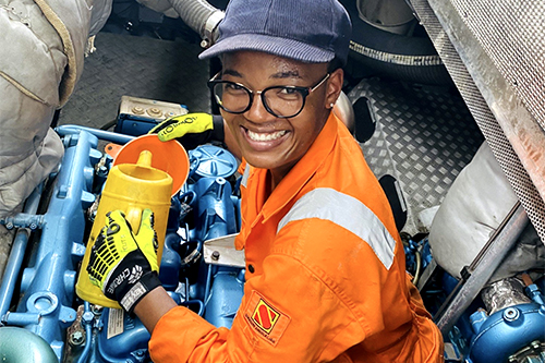 A woman works in an engine.